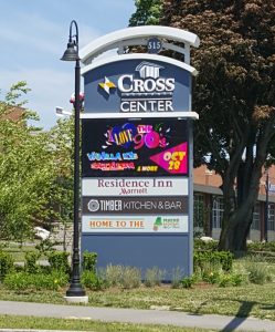 photo of the cross insurance center ID sign designed to match the clock tower of the building. Illuminated channel letters - illuminated tenant panels and LED message center